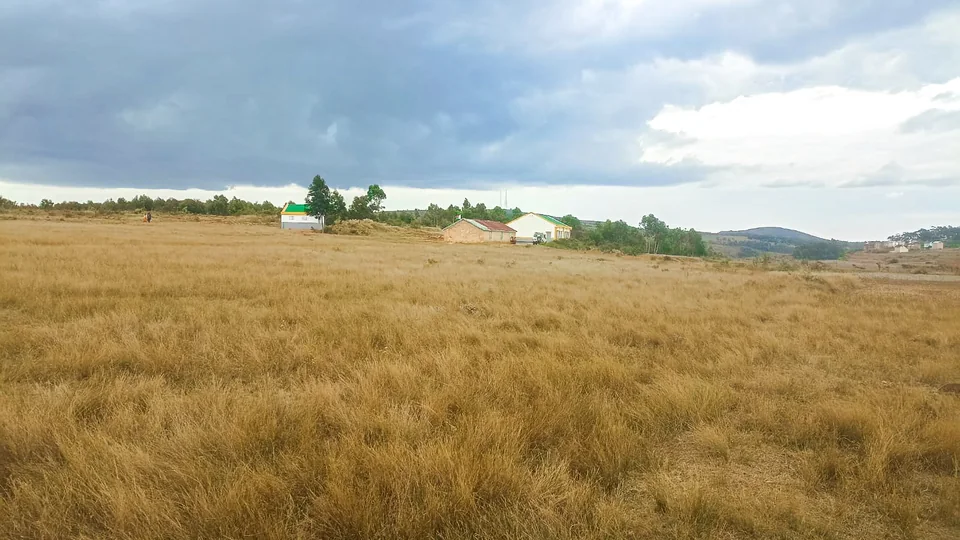 A landscape in Madagascar’s Highlands with fields and distant buildings